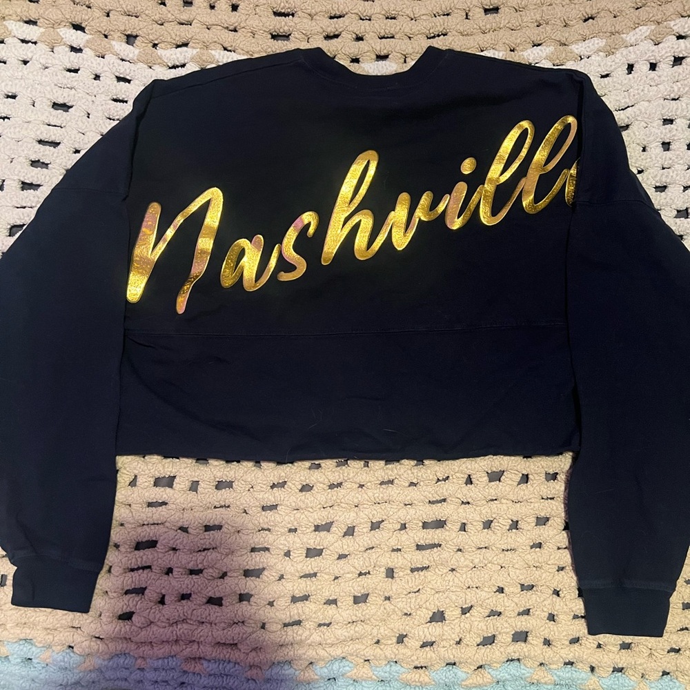 Navy and gold long sleeve top
“nashville” is in the back of sweater!